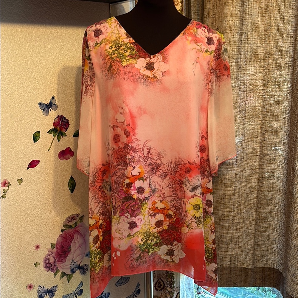 Elegant pink chiffon floral with a half sleeve asymmetrical blouse. Size 1X.